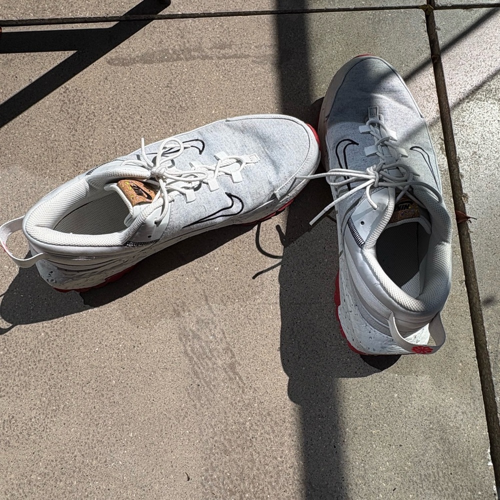 Nike White Athletic Sneakers with Red Outsole Accent